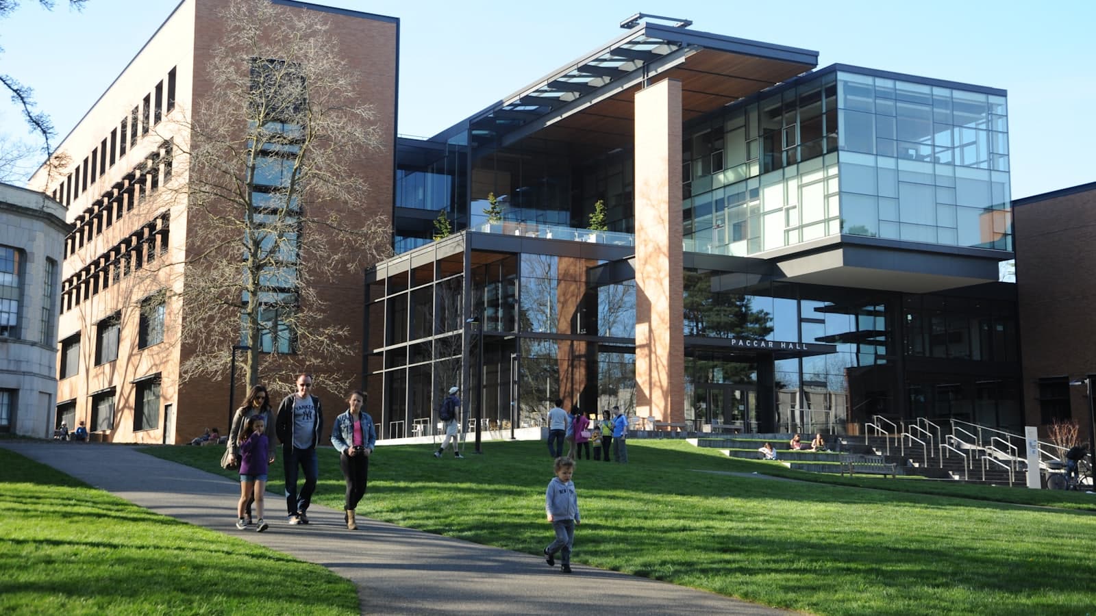 Students walking on a university campus by a modern building